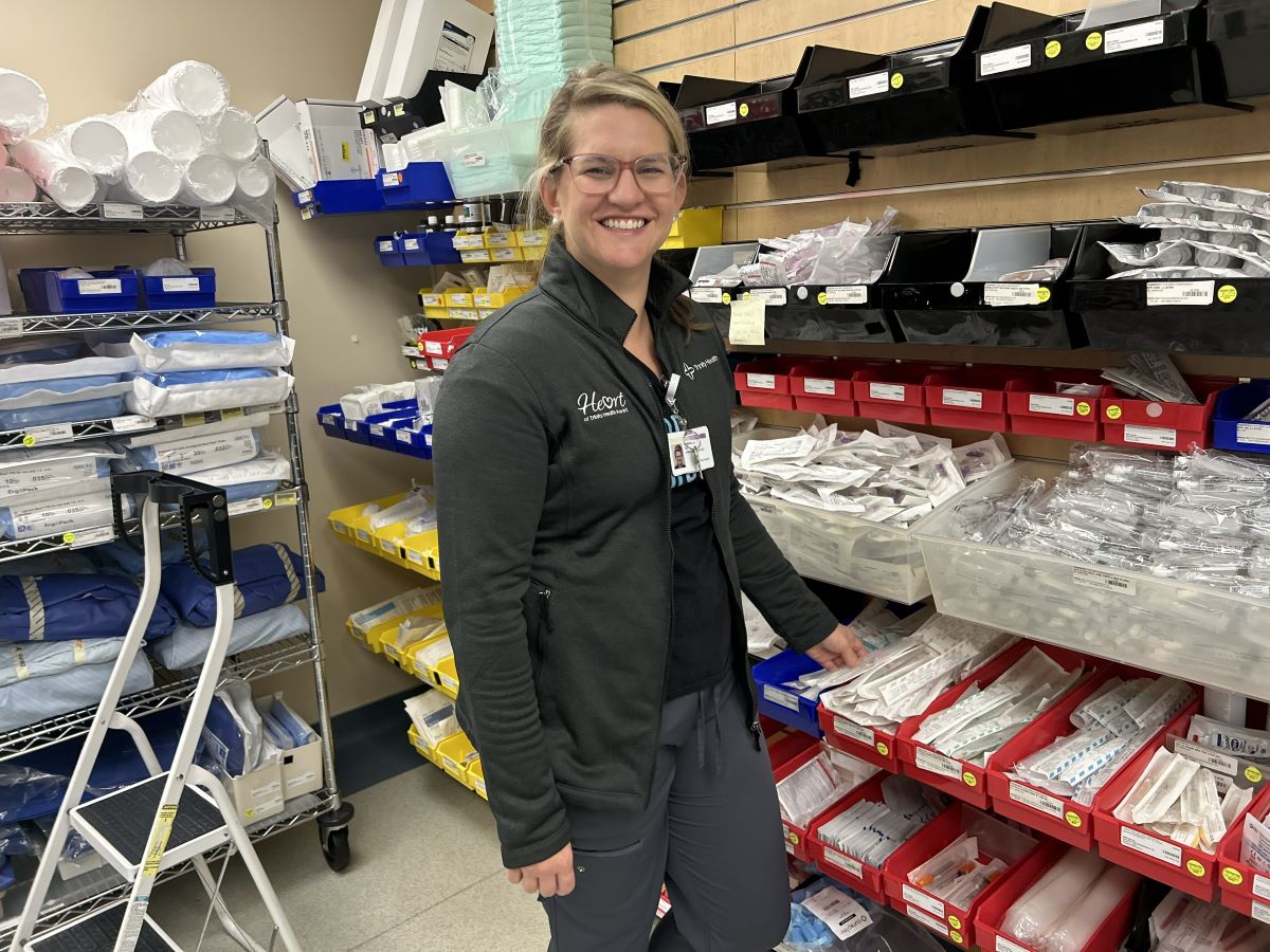 Gabriella in her scrubs in a hospital supply room