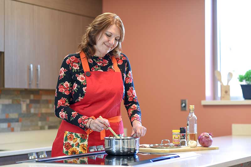 Wendy Boomis cooks in her kitchen after losing a lot of weight