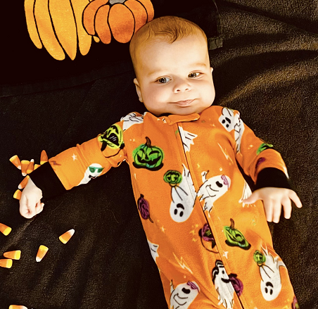 A cute baby in Halloween pajamas